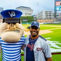 Young man with Louie the Laker at Comerica Park